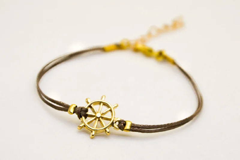 Luxury Pearl Bracelet for Weddings-Brown cord bracelet with a 14k gold plated ship's wheel charm