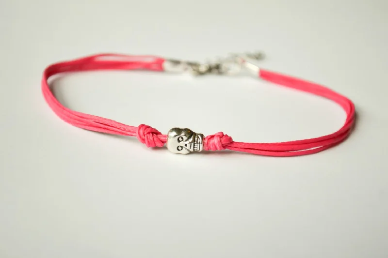 Simple Gold Bangle Bracelet-Pink cord bracelet with a silver skull bead charm, gift for her